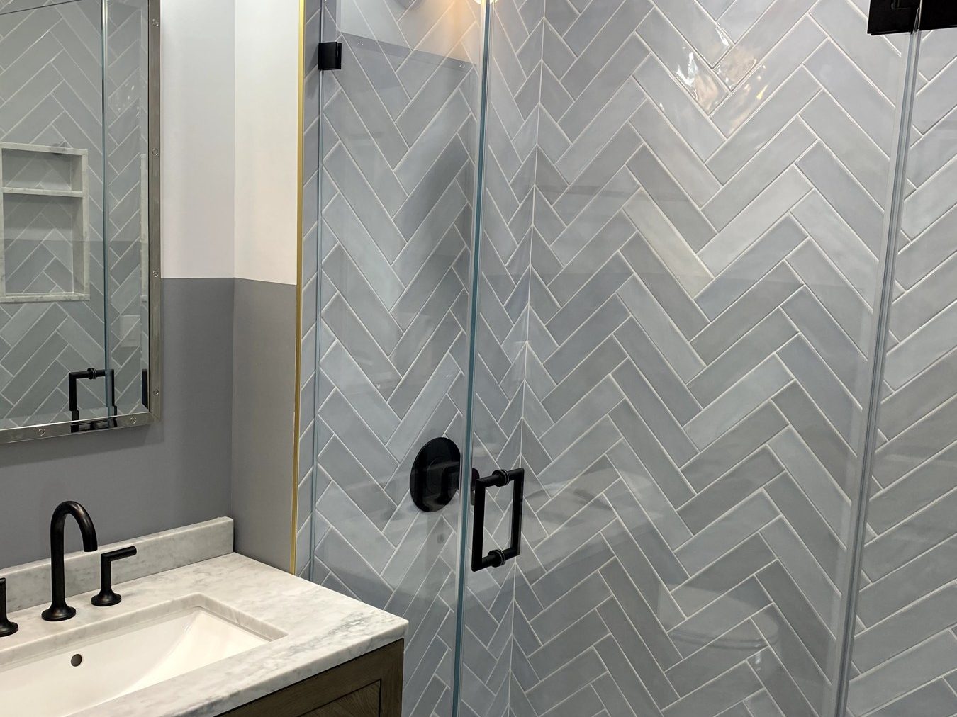 Herringbone tile and glass shower