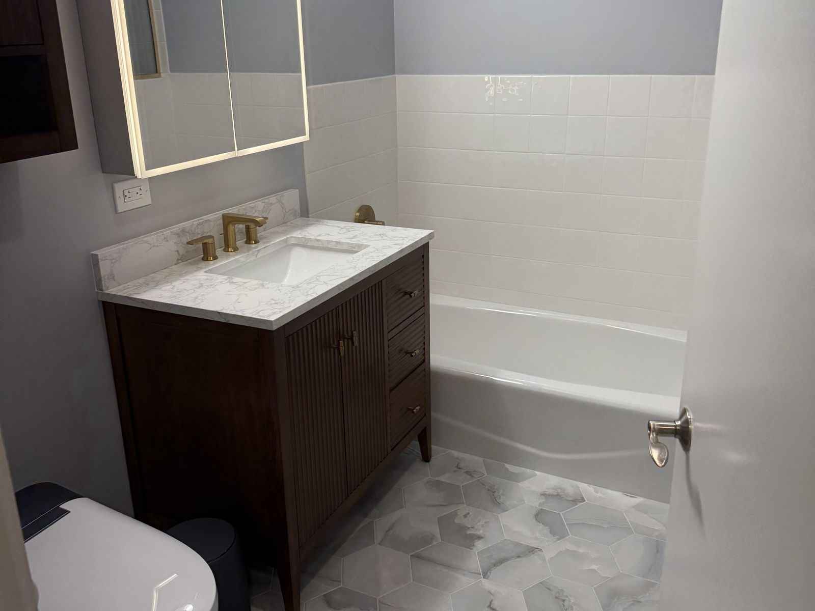 Vanity and lit medicine cabinet