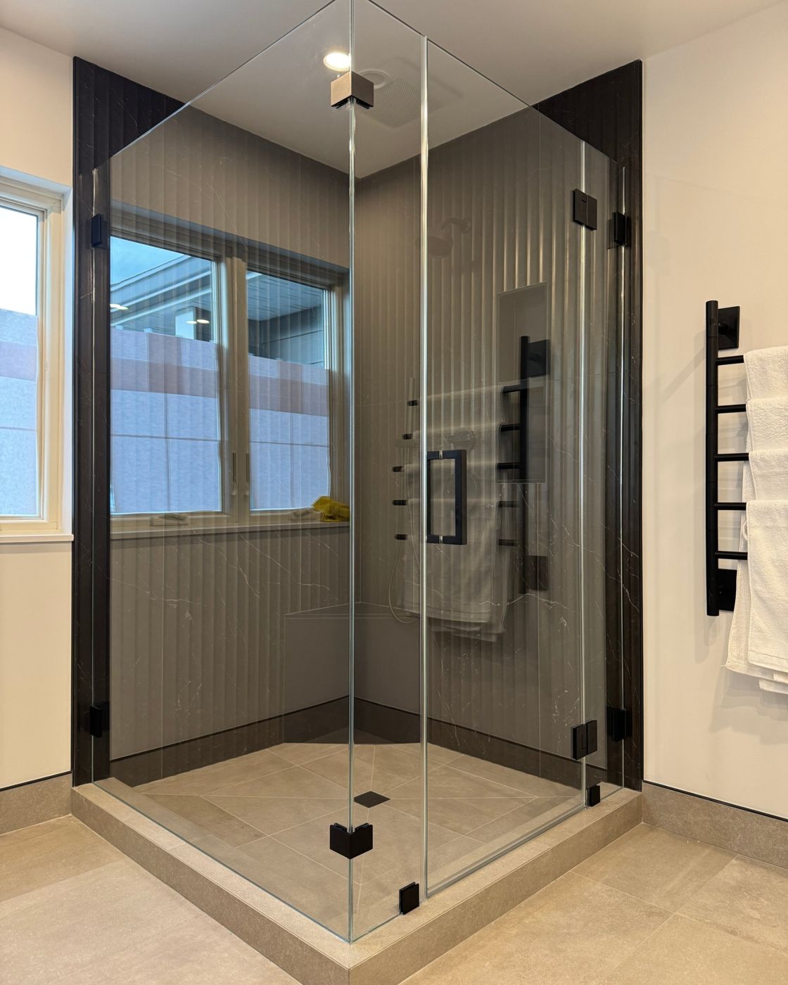 Corner glass shower with black hardware